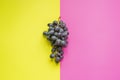 Top view of flat lay of bunch of grapes on double color sirface background f