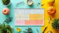 Top view flat lay composition with colorful items and notes arranged near planner calendar on yellow and cyan background Royalty Free Stock Photo