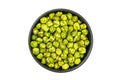 Top view or flat lay of dry crispy wasabi coated green peas in black ceramic bowl Royalty Free Stock Photo