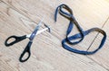 Top view of equipment Scissor and piece of blue fabric jeans on wooden floor background Royalty Free Stock Photo