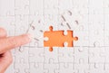 Top view flat lay of hand-holding last piece white paper jigsaw puzzle game last pieces put to place for solve problem complete mi Royalty Free Stock Photo