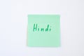 Top view flat lay of hindi language which written on the green reminder notepaper