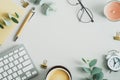 Top view, flat lay keyboard, cup of coffee, paper notebook, pen eucalyptus branches on office desk table. Elegant feminine Royalty Free Stock Photo