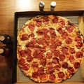 Top view flat lay of a large thin crust Pepperoni pizza with accompaniments