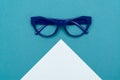 Top view flat lay, modern blue eye glasses on pastel paper background Royalty Free Stock Photo