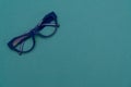 Top view flat lay, modern blue eye glasses on pastel paper background Royalty Free Stock Photo