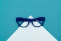 Top view flat lay, modern blue eye glasses on pastel paper background Royalty Free Stock Photo