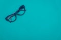 Top view flat lay, modern blue eye glasses on pastel paper background Royalty Free Stock Photo