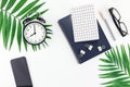 Top view flat lay office workspace desk styled design office supplies alarm clock tropical palm leaves smartphone copy space black