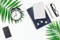 Top view flat lay office workspace desk styled design office supplies alarm clock tropical palm leaves smartphone copy space black