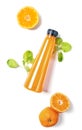 Top view flat lay orange bottle of juice with spinach and orange on white background. Healthy lifestyle, vegetarian food concept