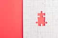 Top view flat lay of paper plain white jigsaw puzzle game texture incomplete or missing piece, studio shot on a red background Royalty Free Stock Photo