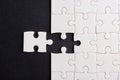 Top view flat lay of paper plain white jigsaw puzzle game texture last pieces for solve and place, studio shot on a black backgrou Royalty Free Stock Photo