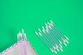 Top view, flat lay, a small group of pink plastic cotton swabs neatly arranged on a green background, the concept of cleanliness Royalty Free Stock Photo