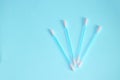 Top view, flat lay, a small group of pink plastic cotton swabs neatly arranged on a mint background, the concept of cleanliness Royalty Free Stock Photo