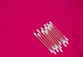 Top view, flat lay, a small group of pink plastic cotton swabs neatly arranged on a red background, the concept of cleanliness and Royalty Free Stock Photo