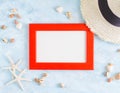 Top view flat lay summer mockup: empty red, photo frame, seashells, straw hat and starfish on blue background. Vacation concept Royalty Free Stock Photo