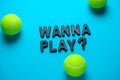 flat lay tennis balls and inscription wanna play on a bright blue background