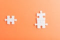 Top view flat lay of three paper plain white jigsaw puzzle game last pieces for solve, studio shot on an orange background Royalty Free Stock Photo