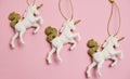 Top view flat lay Unicorns on a pastel pink background. Christmas baubles on a pink. New Year`s decorations layout Royalty Free Stock Photo