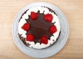 Top view flat lay whip cream frosted chocolate cake with strawberries