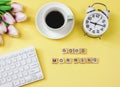 Flat lay of wooden letter GOOD MORNING with computer keyboard, purple white tulip bouquet, coffee cup and vintage alarm clock on Royalty Free Stock Photo