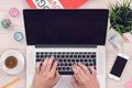 Top view flat lay workspace mockup with iphone smartphone and open macbook laptop with mans hands on office desk Royalty Free Stock Photo