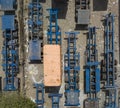 Top view of flatbed semi trailers and containers for rent stored in an empty dirt lot Royalty Free Stock Photo