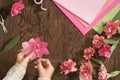 Top view, flatlay. Woman making paper flowers for valentines, woman`s day or holiday concept