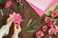 Top view, flatlay. Woman making paper flowers for valentines, woman`s day or holiday concept