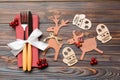 Top view of flatware tied up with ribbon on napkin on wooden background. Close up of christmas decorations and reindeer. New Year