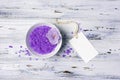 Flavored purple sea salt crystals with violet flower and mock up tag on white