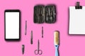 Top flat lay, top view manicure pedicure equipment on pink backgrounew black smartphone isolated on white background for mock up