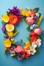 Top view of floral wreath made of beautiful colorful flowers on blue background Royalty Free Stock Photo