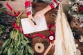 Top view on florist woman making notes Royalty Free Stock Photo