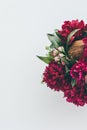 top view of floristry bouquet with pink peonies, roses and coconut on white