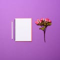 Top view of flower note book with pen on lilac background - Flat lay