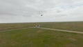 Top view of flying stork. Shot. Following flying bird in field on drone. Drone follows flying white stork over green Royalty Free Stock Photo