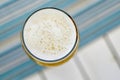 Top view of a foamy mug of cold beer on a hot summer day in a re Royalty Free Stock Photo