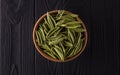 Top view of foglie spinach pasta in bowl on black wooden table Royalty Free Stock Photo