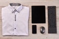 Top view folded shirt with tablet keyboard and mouse.