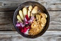 Top View Food Photo of Oatmeal Breakfast Bowl with Sliced Apple, Banana, Dragon Fruit, Coconut Milk, Peanuts and Peanut Butter on