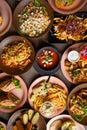 Top view of food on table in restaurant cafe. Pasta with shrimps. Caesar salad with croutons. Sandwiches with lettuce. Royalty Free Stock Photo