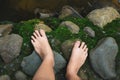 top view. foot of woman stand on wet rock floor with green moss Royalty Free Stock Photo