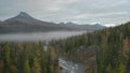 Top view of forest landscape with river and mountains with fog. Clip. Beautiful cloudy day over forest valley with river Royalty Free Stock Photo