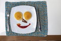 Top view of fork and knife next to breakfast plate on dining table On the plate were pancakes, syrup, crispy bacon and ketchup. Royalty Free Stock Photo