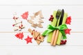 Top view of fork and knife tied up with ribbon on napkin on wooden background. Close up of christmas decorations and New Year tree