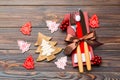 Top view of fork and knife tied up with ribbon on napkin on wooden background. Close up of christmas decorations and New Year tree