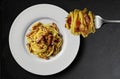 Top view of Plate with spaghetti carbonara on black stone Royalty Free Stock Photo