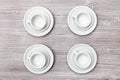 Top view of four cups and saucers on gray table Royalty Free Stock Photo